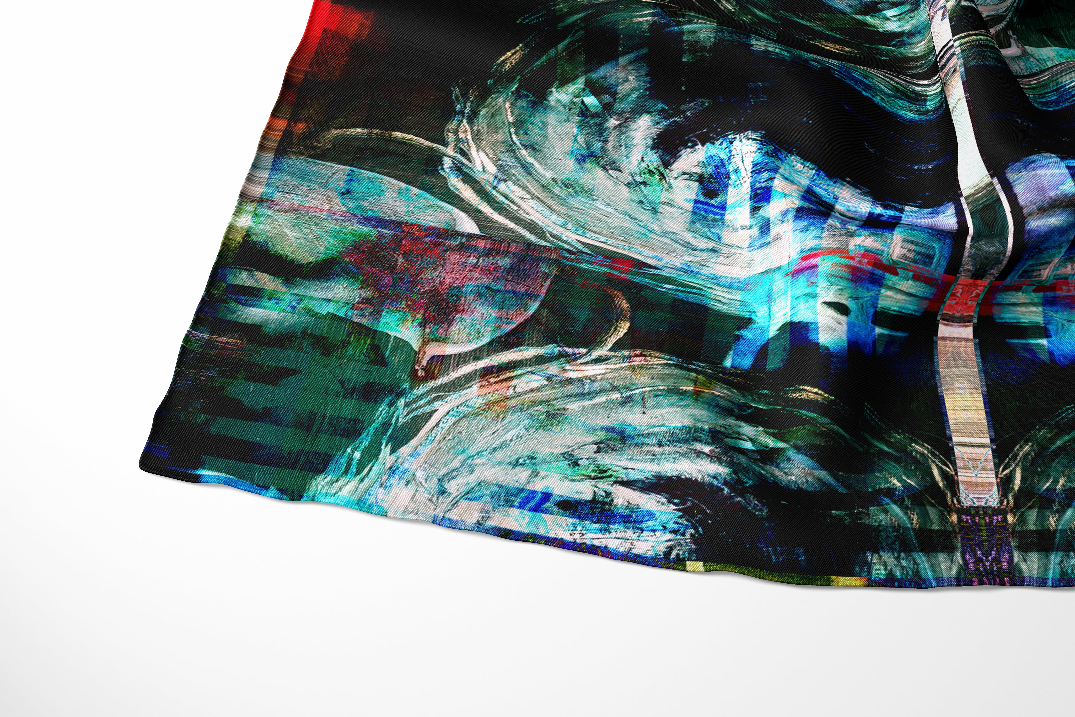 detail of an abstract printed Aurelio Costarella silk scarf in tones on blue, purple, black and red. printed onto a semi transparent fine smotth silk cotton bland fabric