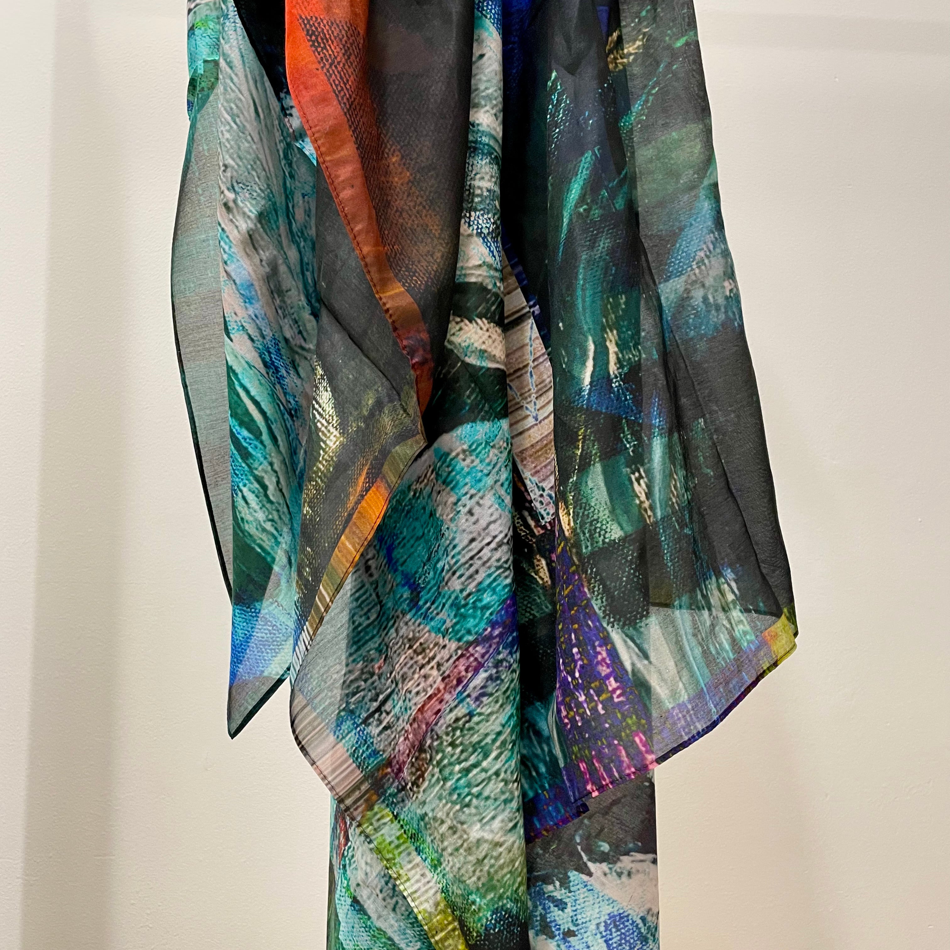abstract printed silk scarf in tones on blue, purple, black and red. printed onto a semi transparent fine smotth silk cotton bland fabric