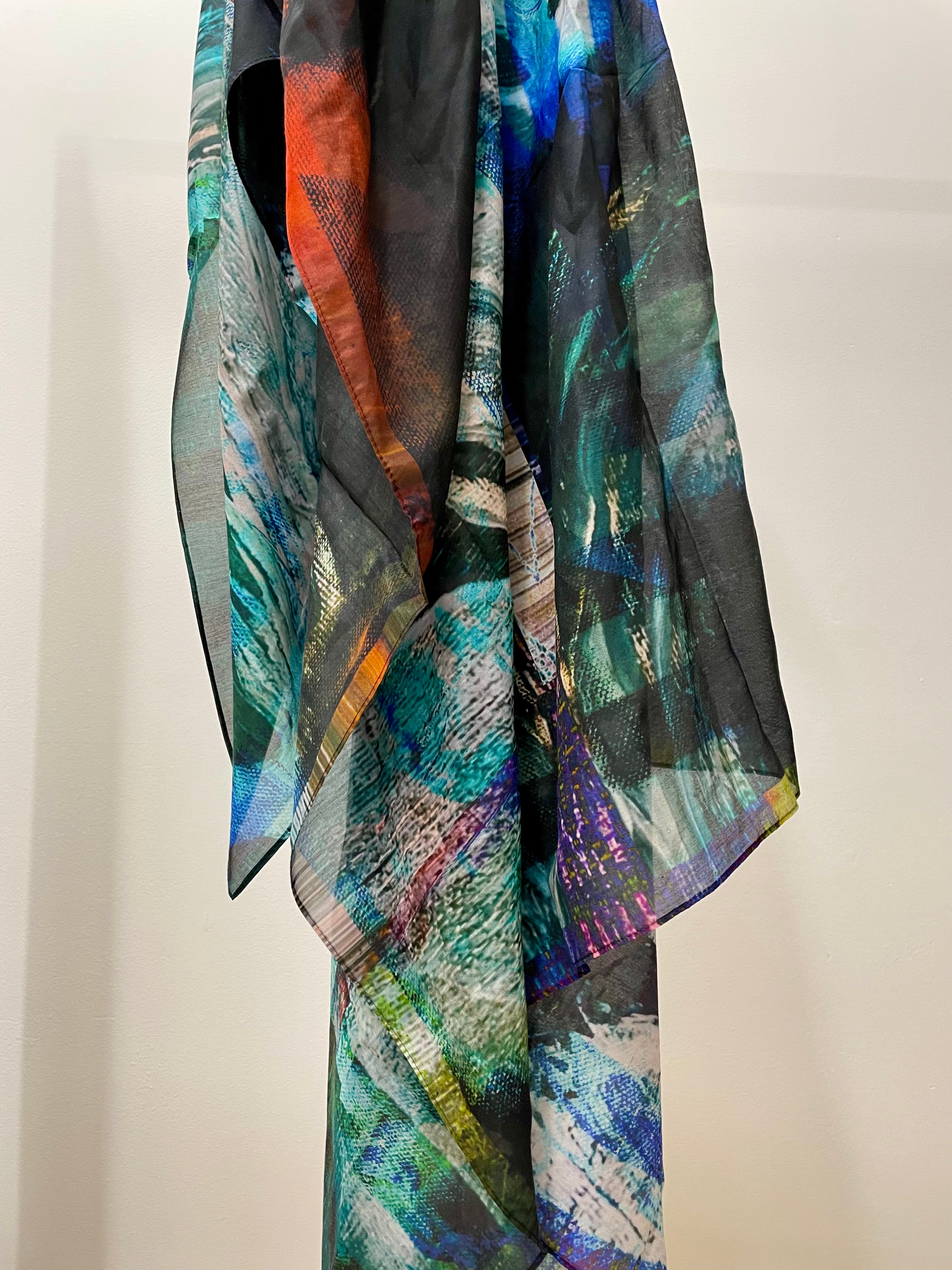 abstract printed silk scarf in tones on blue, purple, black and red. printed onto a semi transparent fine smotth silk cotton bland fabric