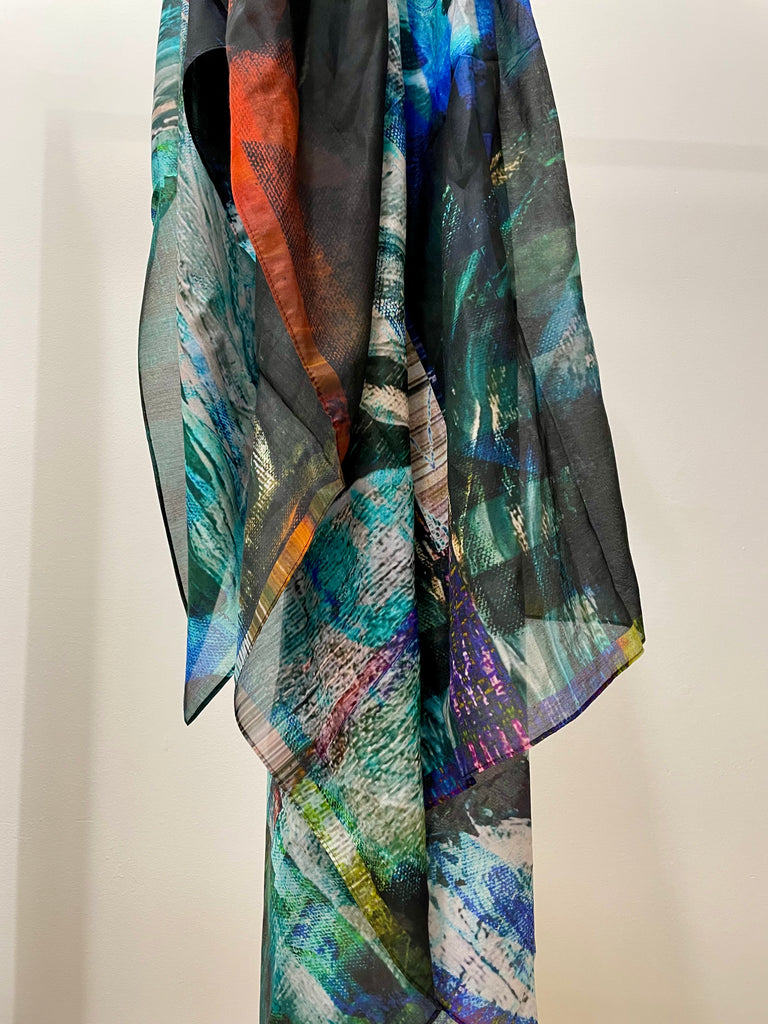 abstract printed silk scarf in tones on blue, purple, black and red. printed onto a semi transparent fine smotth silk cotton bland fabric 